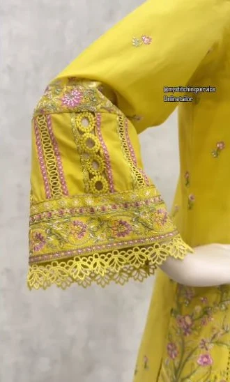 Yellow sleeve with pink embroidery and a delicate lace edge